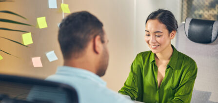 Positive delighted woman sitting at her workplace
